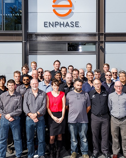 Group of people standing in front of Enphase building. 