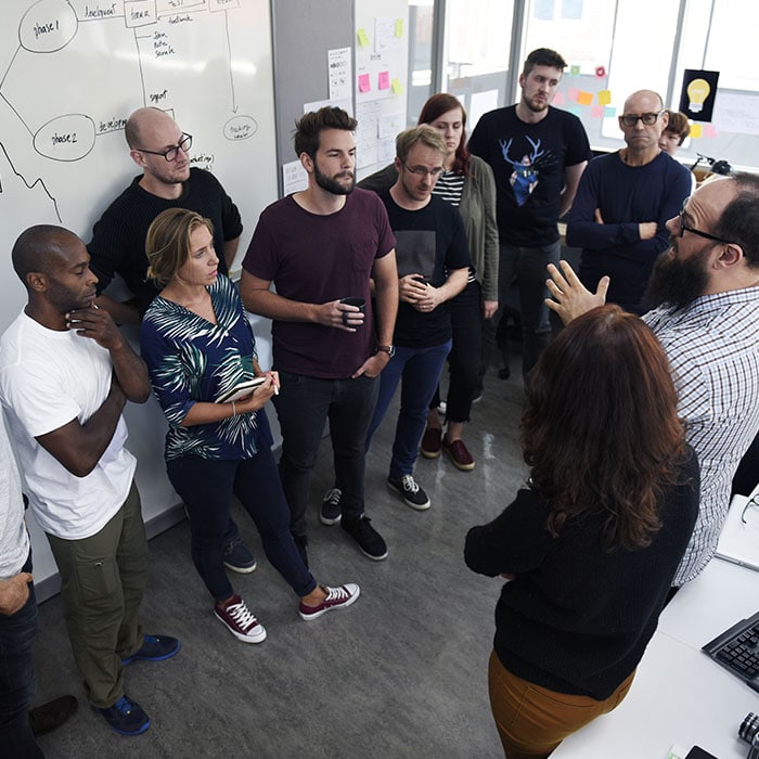Standup meeting of employees at a startup company.